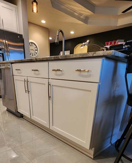 wide angle view of a kitchne island and cabinets that have been repainted