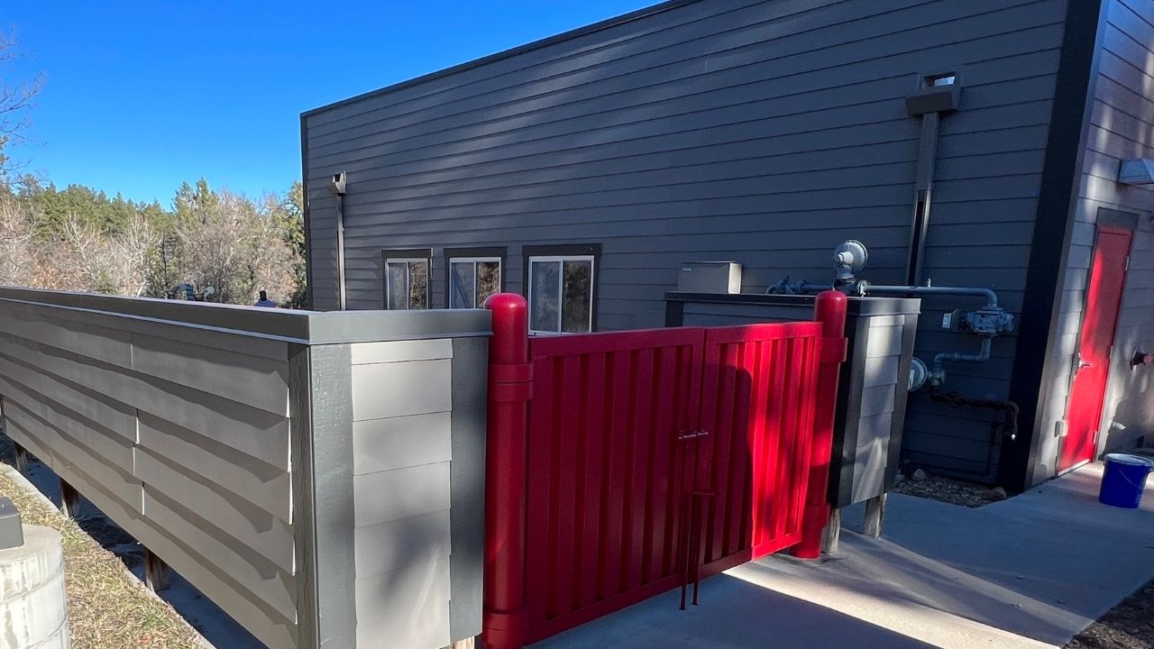 Exterior view of a commercial building newly painted in red and gray.