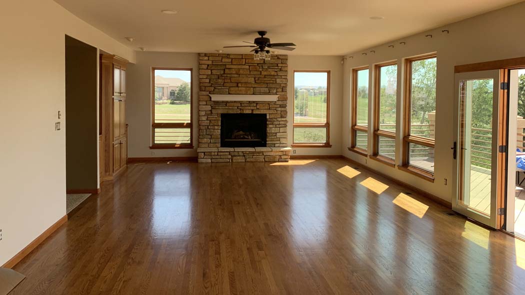 sunlit interior with a fireplace and wood floor displaying the interior painting completed by Elk Horn Painting