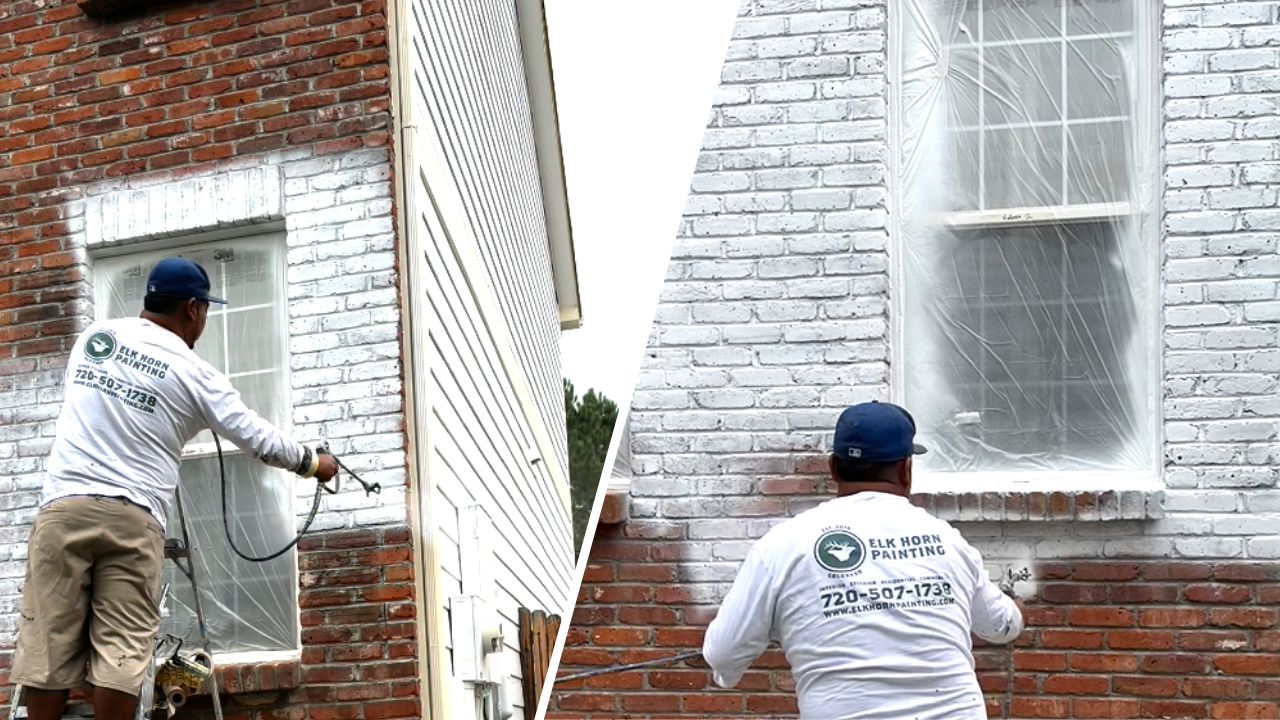 Image of a painter meticulously applying paint to the home's brick exterior using a sprayer.