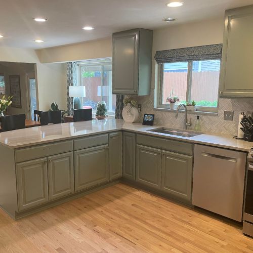 Cabinet Painting - Elk Horn Painting - Denver This image showcases a freshly painted kitchen with sage green cabinets by Elk Horn Painting – Denver, creating a warm and modern interior update.