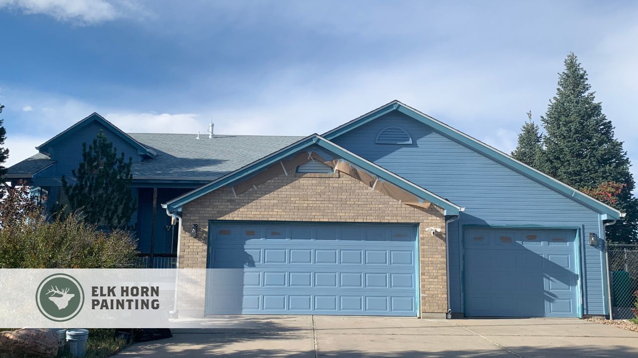 A home in Denver CO undergoing exterior painting with surfaces thoroughly cleaned and primed to withstand sun, snow, and moisture.
