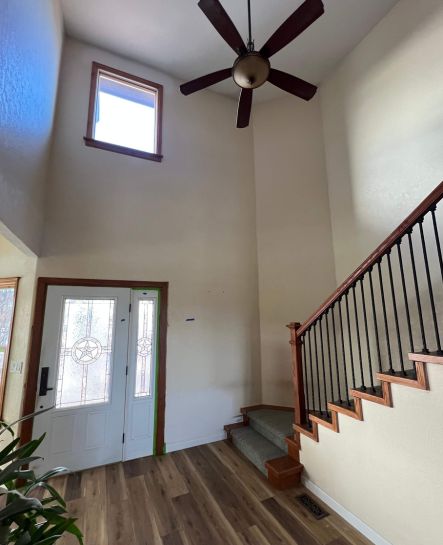 Image of a house entryway wall and staircase, freshly painted to brighten the space and enhance its appeal.