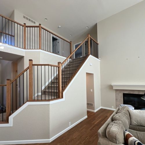 Interior Painting - Elk Horn Painting - Denver Newly painted staircase and living room walls showcasing a smooth, clean finish that enhances the interior space.