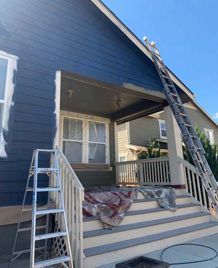 Porch and exterior of a house being painted in denver, CO.