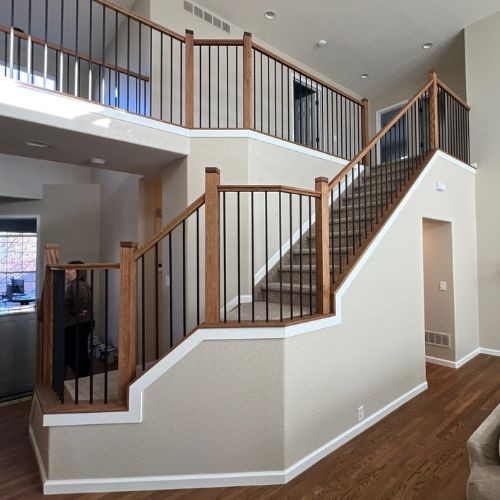 Painting Contractors - Elk Horn Painting - Denver An interior stairway painting project by Elk Horn Painting – Denver, highlighting crisp wall lines and expertly finished wood and metal railings.