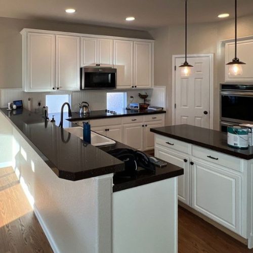 Professional Painters - Elk Horn Painting - Denver Freshly painted kitchen cabinets showcasing a smooth, high-quality finish delivered by professional painters in Denver, CO.