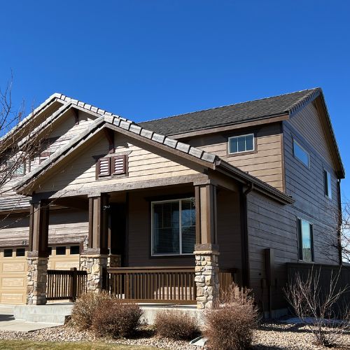 Residential Painting - Elk Horn Painting - Denver A beautifully painted two-story home exterior by Elk Horn Painting – Denver, featuring natural wood tones and stone accents.