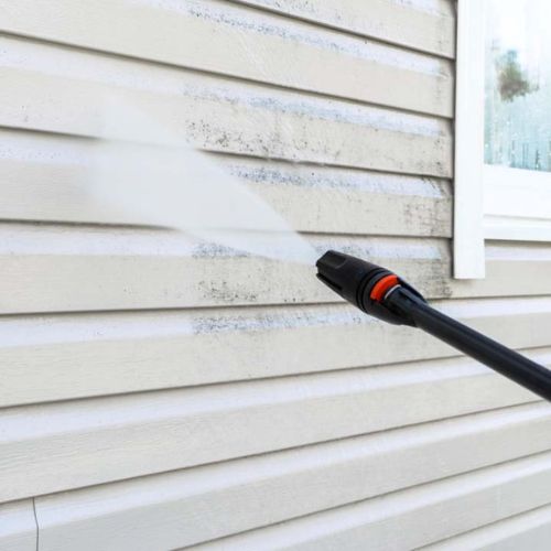 Pressure Washing - Elk Horn Painting - Denver A close-up of professional pressure washing on a home's exterior siding by Elk Horn Painting – Denver, removing built-up dirt and mildew.