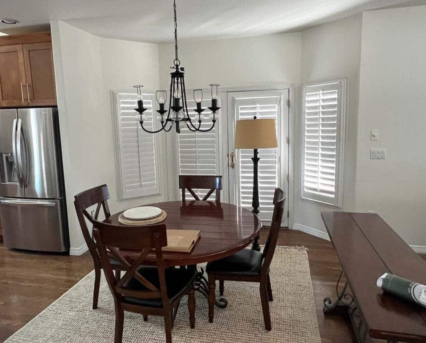 Interior Painting in Commerce City - CO in progress as a painter rolls a bright living room wall