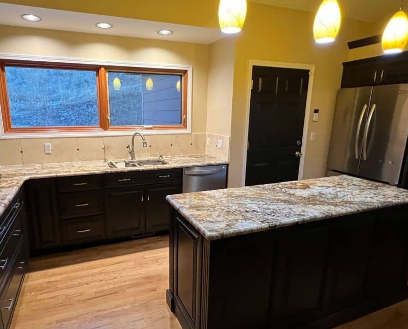 Skilled painter inspecting smooth trim lines and wall finish in upscale interior. Interior Painting near me.
