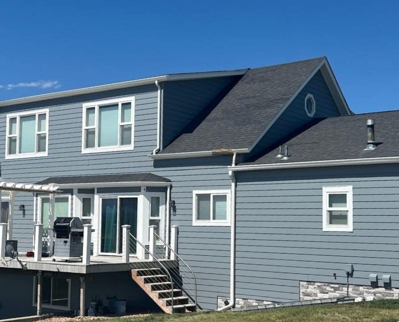Experienced painter checking siding condition and surface readiness before exterior repainting. Exterior Painting near me.